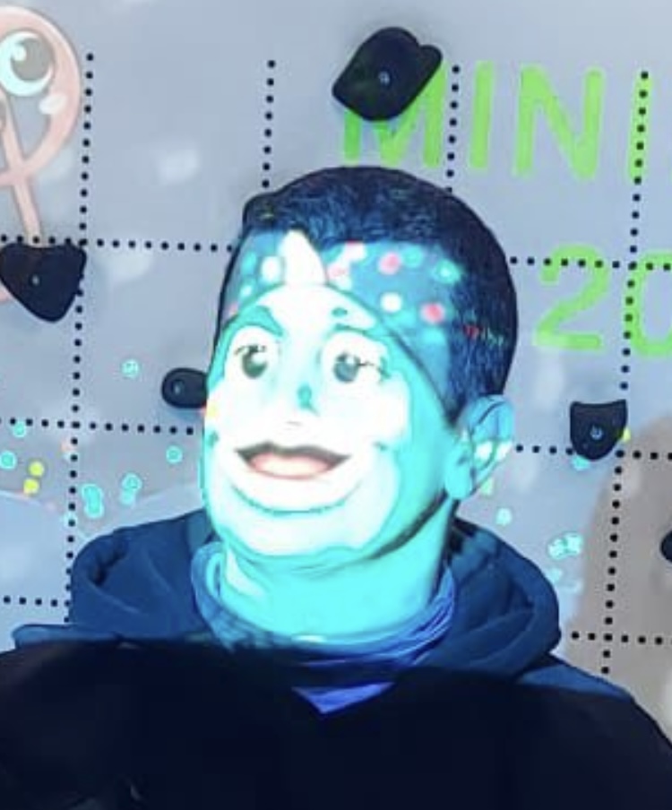 My face with a picture of a cartoon fish projected on it.