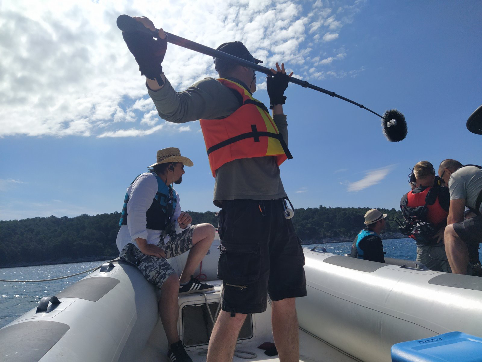 Daniel operating a boom microphne on a boat.